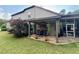 Rear exterior showing a covered patio and bar area, ideal for outdoor entertaining at 5403 Timber Wild Ln, Buford, GA 30518