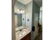 Bathroom featuring a granite countertop vanity, decorative mirror, and great lighting at 5403 Timber Wild Ln, Buford, GA 30518
