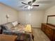 Cozy bedroom with a ceiling fan, warm colors, and a dresser at 5403 Timber Wild Ln, Buford, GA 30518