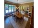 Bright dining room with hardwood floors, a large window, and an elegant chandelier at 5403 Timber Wild Ln, Buford, GA 30518