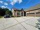 Brick home featuring a long driveway leading to an attached two-car garage at 5403 Timber Wild Ln, Buford, GA 30518