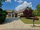 Charming brick home with a well-manicured front yard, long driveway, and attached garage at 5403 Timber Wild Ln, Buford, GA 30518