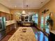 Open-concept kitchen overlooking living spaces, with granite counters and hardwood flooring at 5403 Timber Wild Ln, Buford, GA 30518