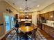 Spacious kitchen with an island, stainless steel appliances, and a dining area with backyard views at 5403 Timber Wild Ln, Buford, GA 30518