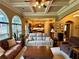 Open-concept living room with coffered ceilings, large windows, and seamless flow to the kitchen at 5403 Timber Wild Ln, Buford, GA 30518