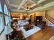 Bright living room with hardwood floors, coffered ceilings, and views into the kitchen at 5403 Timber Wild Ln, Buford, GA 30518