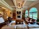 Spacious living room featuring a stone fireplace, built-in shelves, and coffered ceilings at 5403 Timber Wild Ln, Buford, GA 30518