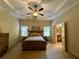Comfortable main bedroom with tray ceilings, neutral tones, and a great view at 5403 Timber Wild Ln, Buford, GA 30518