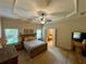Serene main bedroom featuring a tray ceiling, neutral tones, and ensuite bathroom at 5403 Timber Wild Ln, Buford, GA 30518