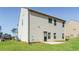 A large backyard with a green lawn, the rear of the home, and an air conditioning unit at 89 Citadel Dr, Hampton, GA 30228