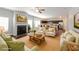 A staged living room featuring a fireplace, plush seating, and an open layout connecting to the kitchen at 89 Citadel Dr, Hampton, GA 30228