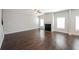 Spacious living room featuring hardwood floors, a cozy fireplace, and plenty of natural light from large windows at 89 Citadel Dr, Hampton, GA 30228