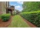 View of backyard with lawn, patio and beautiful landscaping at 125 Windy Pines Pass, Roswell, GA 30075