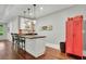 Home bar featuring granite countertops, pendant lighting, seating, and a red metal storage locker at 125 Windy Pines Pass, Roswell, GA 30075