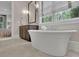 Bright bathroom featuring a soaking tub and a view to the bedroom at 125 Windy Pines Pass, Roswell, GA 30075