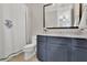 Bathroom vanity with custom blue cabinetry and a shower curtain at 125 Windy Pines Pass, Roswell, GA 30075