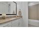 Bright bathroom featuring a granite vanity and tiled shower at 125 Windy Pines Pass, Roswell, GA 30075