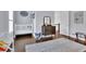 Light-filled bedroom featuring hardwood floors and a classic wooden crib at 125 Windy Pines Pass, Roswell, GA 30075