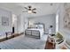 Stylish bedroom featuring hardwood floors, a wrought iron bed frame, and ample natural light at 125 Windy Pines Pass, Roswell, GA 30075