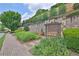 Bench swing in the community with brick walls and landscaping at 125 Windy Pines Pass, Roswell, GA 30075