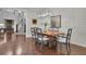 Dining room with hardwood floors, a decorative light fixture, shiplap accent wall and view of the staircase at 125 Windy Pines Pass, Roswell, GA 30075