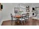 Dining area with wood table, modern lighting, wood floors and shiplap accent wall at 125 Windy Pines Pass, Roswell, GA 30075