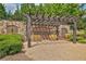Common area with stone wall, wooden pergola with seating at 125 Windy Pines Pass, Roswell, GA 30075