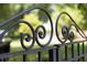 An elaborate wrought iron gate adds detail to the landscape at 125 Windy Pines Pass, Roswell, GA 30075