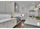 Modern kitchen with stainless steel appliances, quartz countertops, and a gas range, featuring white cabinets at 125 Windy Pines Pass, Roswell, GA 30075