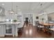 Open-concept kitchen and dining area with hardwood floors, a large island with seating, and stainless steel appliances at 125 Windy Pines Pass, Roswell, GA 30075