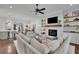 An open-concept living space featuring a fireplace, built-in shelves, and a kitchen island with seating at 125 Windy Pines Pass, Roswell, GA 30075