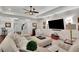Bright living room showcasing shiplap walls, a large TV, neutral furniture, and hardwood floors at 125 Windy Pines Pass, Roswell, GA 30075