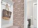 Mudroom with patterned wallpaper and a bag on a hook at 125 Windy Pines Pass, Roswell, GA 30075