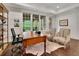 Home office featuring large windows, hardwood floors, a cowhide rug, and classic furniture at 125 Windy Pines Pass, Roswell, GA 30075
