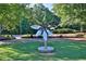 Park with stainless steel flower sculpture surrounded by green grass and trees at 125 Windy Pines Pass, Roswell, GA 30075