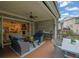 Entertain on a spacious covered patio, featuring comfortable seating and outdoor dining at 125 Windy Pines Pass, Roswell, GA 30075