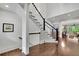 Beautiful staircase with dark wood floors and black and white banister at 125 Windy Pines Pass, Roswell, GA 30075