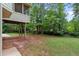 Grassy backyard with mature trees, providing a peaceful setting for outdoor activities and relaxation at 1720 Greystone Trce, Conyers, GA 30013