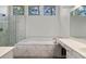 Luxurious primary bath with a soaking tub and marble tile shower at 1720 Greystone Trce, Conyers, GA 30013