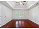 Bedroom with hardwood floors, tray ceiling, ceiling fan and natural light at 1720 Greystone Trce, Conyers, GA 30013