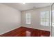 Bedroom with hardwood floors, two windows with wooded views, and a closet at 1720 Greystone Trce, Conyers, GA 30013