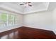 Large primary bedroom with tray ceilings and hardwood flooring at 1720 Greystone Trce, Conyers, GA 30013