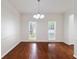 Spacious dining room features hardwood floors, chandelier, and natural light from windows at 1720 Greystone Trce, Conyers, GA 30013