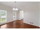 Bright dining room featuring hardwood floors, white walls, and window views at 1720 Greystone Trce, Conyers, GA 30013