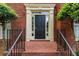 Inviting front door with decorative molding, side windows, and elegant landscaping at 1720 Greystone Trce, Conyers, GA 30013
