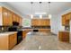 Kitchen with island, breakfast bar, tile backsplash and hardwood cabinets at 1720 Greystone Trce, Conyers, GA 30013
