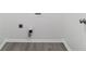 Clean, bright laundry room with gray flooring, white trim, and laundry hook-ups for convenience at 1720 Greystone Trce, Conyers, GA 30013