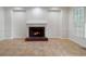 Bright living room features a brick fireplace and tile flooring at 1720 Greystone Trce, Conyers, GA 30013