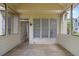 Inviting porch with wood flooring, paneled walls, and multiple windows for enjoying the outdoors at 1720 Greystone Trce, Conyers, GA 30013