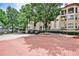 Exterior view of gated Palazzo Bocce community, lush trees, and brick driveway at 955 Juniper Ne St # 2322, Atlanta, GA 30309